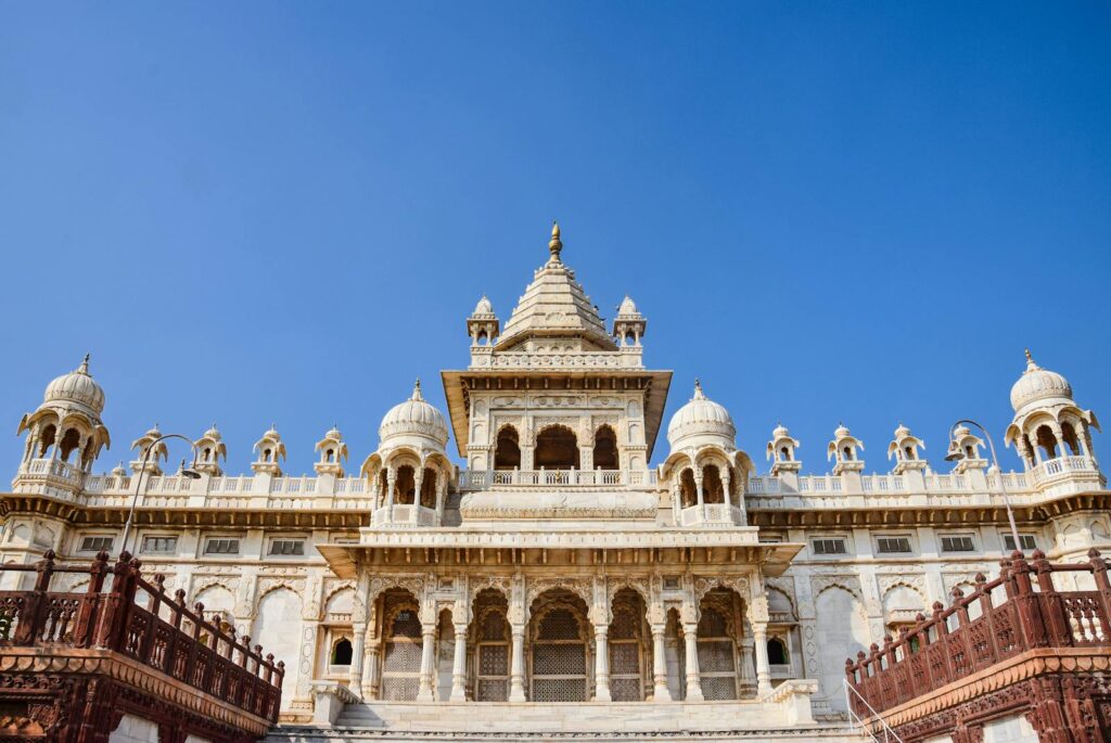 Stunning view of a traditional Indian palace with intricate marble architecture against a clear sky.