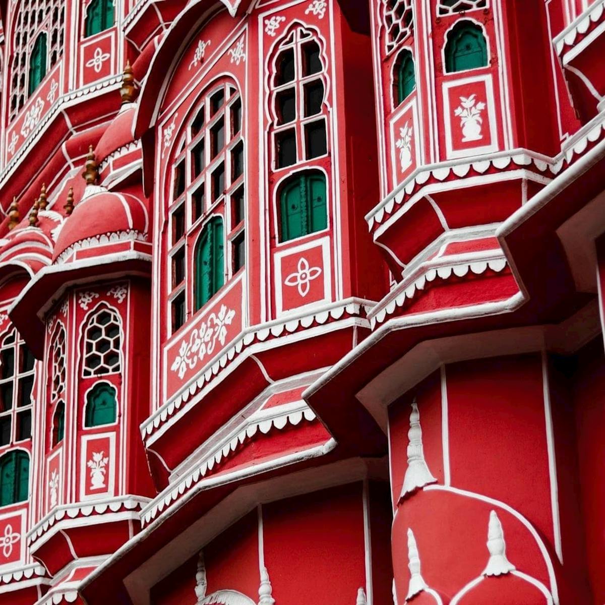 Detailed view of the intricate red facade of Hawa Mahal in Jaipur, India. Captivating architectural beauty.